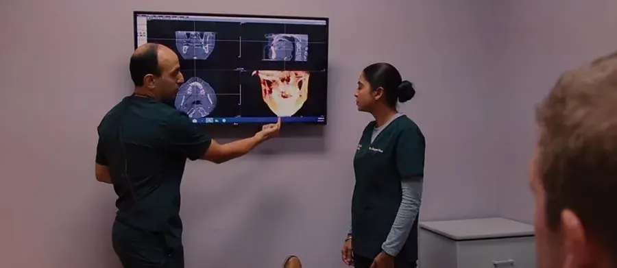 Dr. Modarres and Dr. Khatra going over a 3D scan on a wall screen.