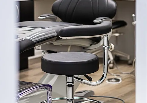 A black leather treatment chair in one of the operatories.