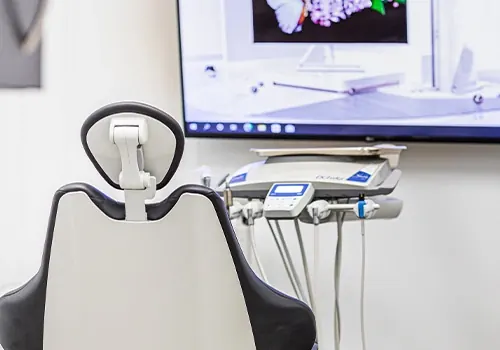 A treatment room, with a screen above the chair.