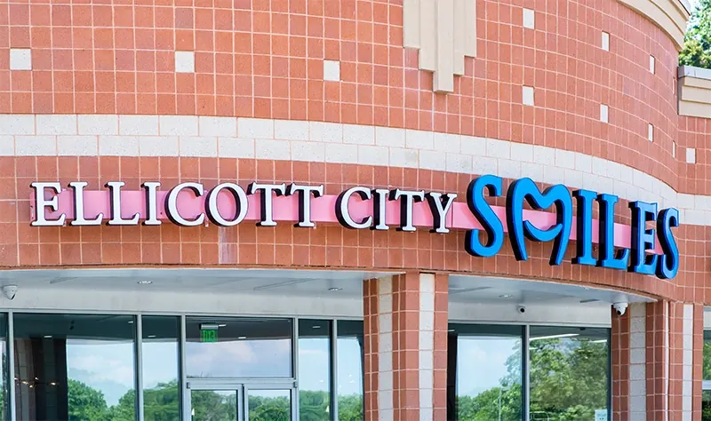 The Ellicott City Smiles sign above the office's glass frontage on Baltimore National Pike.